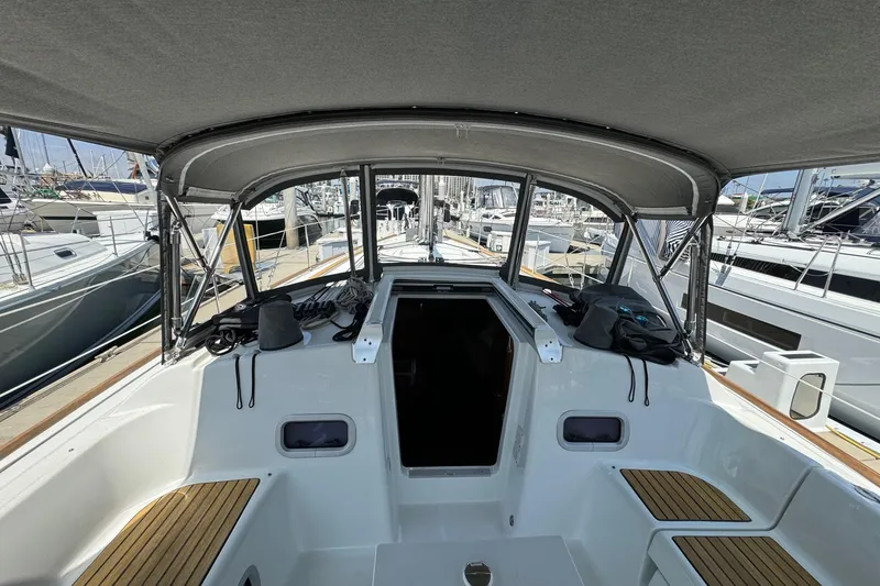 Slide: The Image of 2017 Beneteau Oceanis 37 sailboat cockpit with canopy, docked at marina. - 18