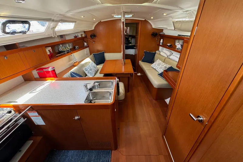 Slide: The Image of Interior of 2017 Beneteau Oceanis 37 yacht with cozy seating and modern kitchen area. - 23