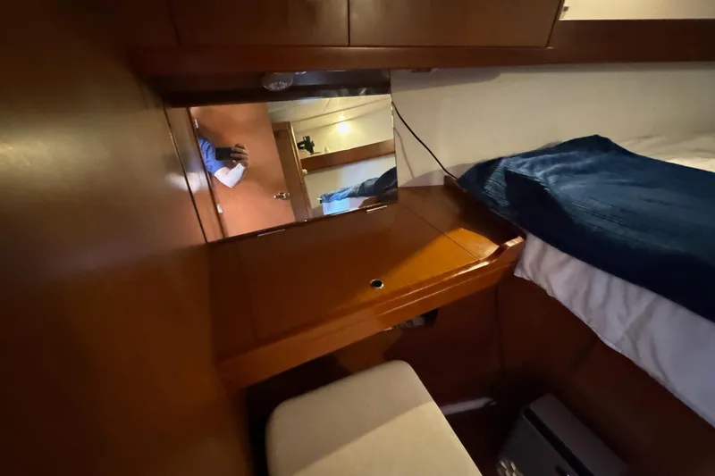 Slide: The Image of Cozy cabin interior of 2017 Beneteau Oceanis 37 sailboat with wooden furnishings and blue bedding. - 29