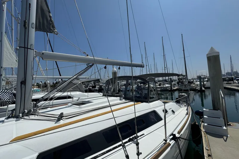 Slide: The Image of 2017 Beneteau Oceanis 37 sailboat docked at marina under clear blue sky. - 5