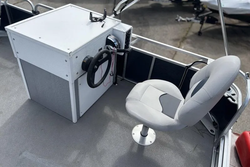Slide: The Image of 2020 Apex Gillgetter 7515 Tiller boat interior with steering console and cushioned seat. - 9