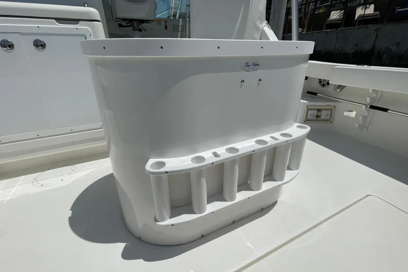 Slide: The Image of 2005 Rampage 33 Express boat deck with rod holders and storage. - 14