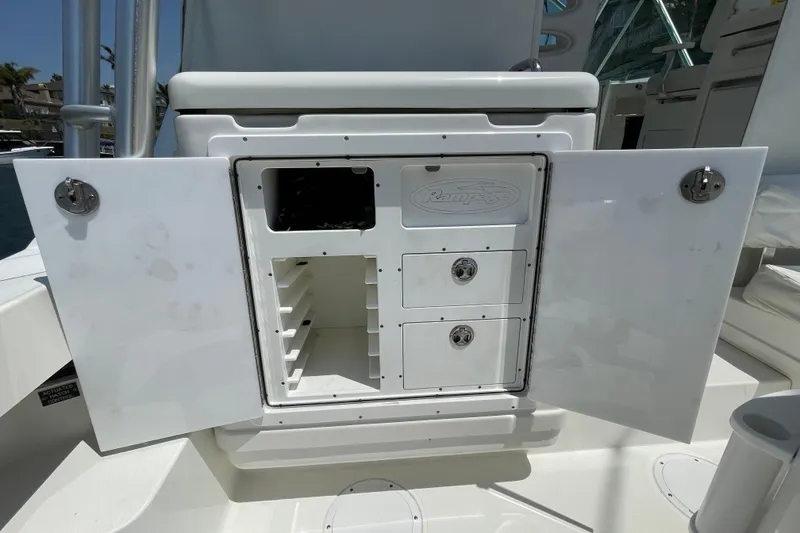 Slide: The Image of 2005 Rampage 33 Express boat storage compartment with open doors and drawers. - 16
