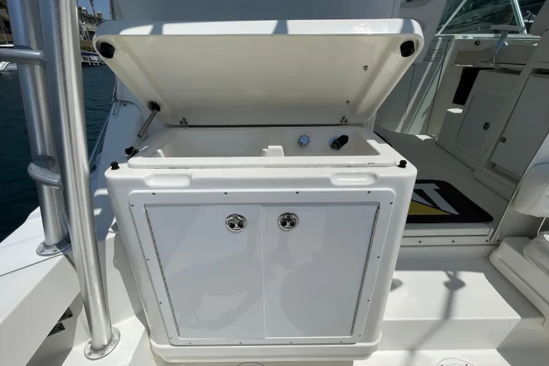 Slide: The Image of 2005 Rampage 33 Express boat with open storage compartment on deck. - 18