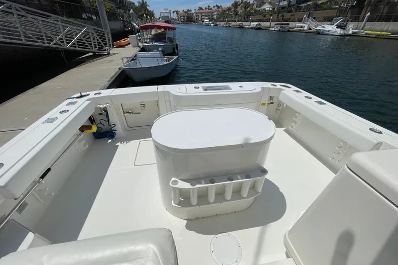 Slide: The Image of 2005 Rampage 33 Express boat deck with seating, docked in a marina. - 19