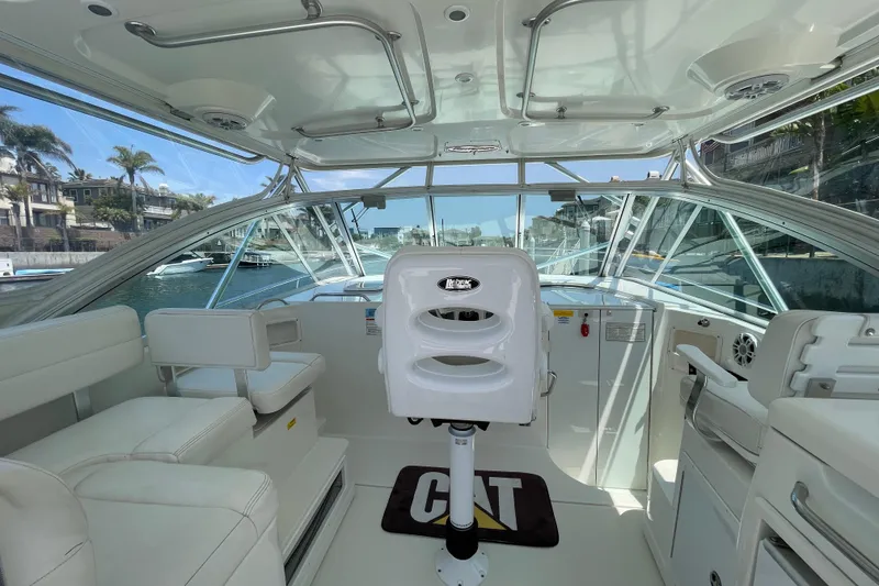 Slide: The Image of Interior view of a 2005 Rampage 33 Express boat, featuring a sleek helm and seating area. - 20