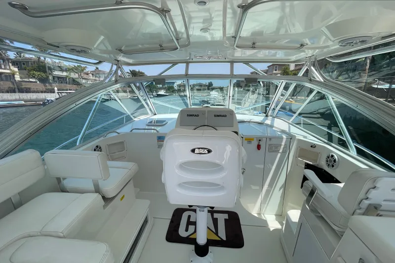 Slide: The Image of 2005 Rampage 33 Express yacht interior with helm, seating, and navigation equipment. - 21