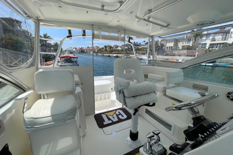 Slide: The Image of Interior view of a 2005 Rampage 33 Express boat with luxurious seating and steering wheel. - 30
