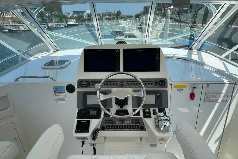 Slide: The Image of Helm of 2005 Rampage 33 Express boat with modern navigation equipment. - 32