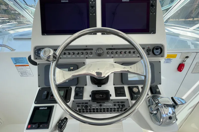 Slide: The Image of 2005 Rampage 33 Express helm with steering wheel and navigation controls. - 33