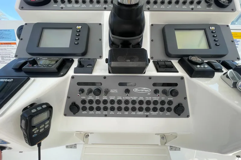 Slide: The Image of Control panel of a 2005 Rampage 33 Express boat with various instruments and displays. - 35