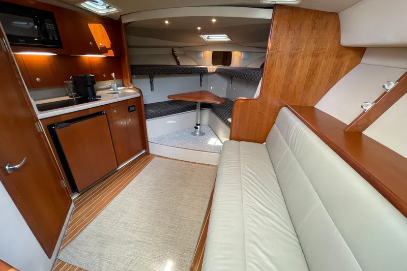 Slide: The Image of Luxurious 2005 Rampage 33 Express yacht interior with kitchenette, seating, and dining area. - 36