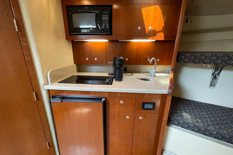 Slide: The Image of 2005 Rampage 33 Express yacht kitchen with microwave, sink, and compact fridge. - 40