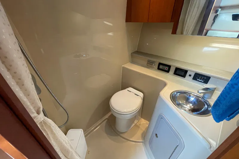 Slide: The Image of 2005 Rampage 33 Express boat bathroom with toilet, sink, and shower. - 42