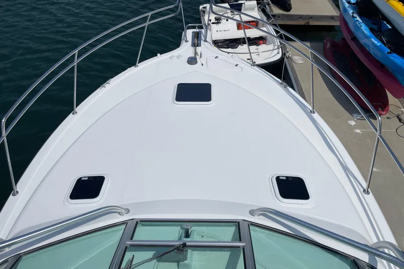 Slide: The Image of Bow view of 2005 Rampage 33 Express boat docked at marina. - 44