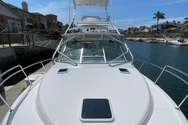 Slide: The Image of 2005 Rampage 33 Express boat docked in a marina, showcasing sleek design and spacious deck. - 45