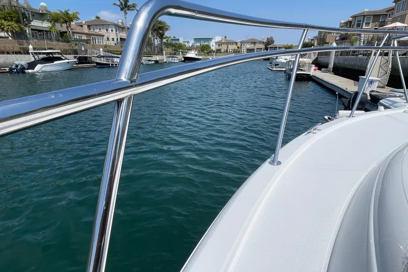 Slide: The Image of 2005 Rampage 33 Express yacht docked in a marina, with clear blue water. - 47