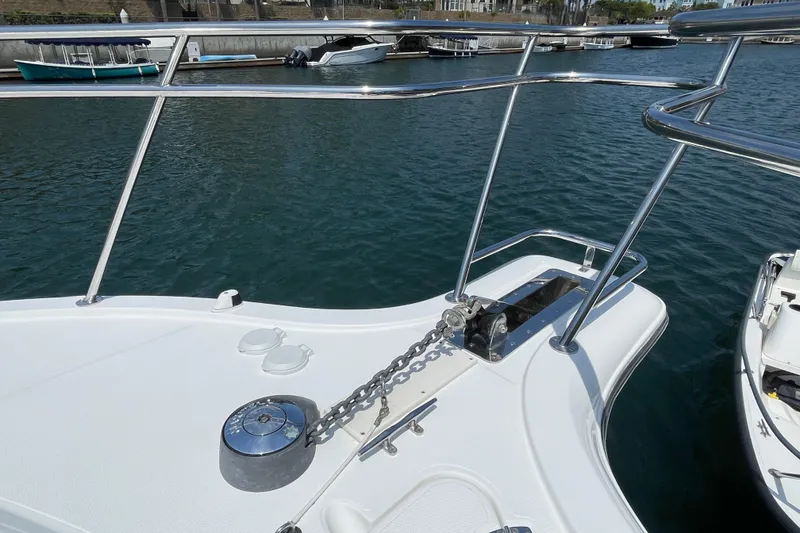 Slide: The Image of Bow of 2005 Rampage 33 Express boat with anchor chain and railing, docked in marina. - 48