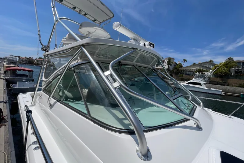 Slide: The Image of 2005 Rampage 33 Express boat docked, featuring sleek design and sturdy metal framework. - 50