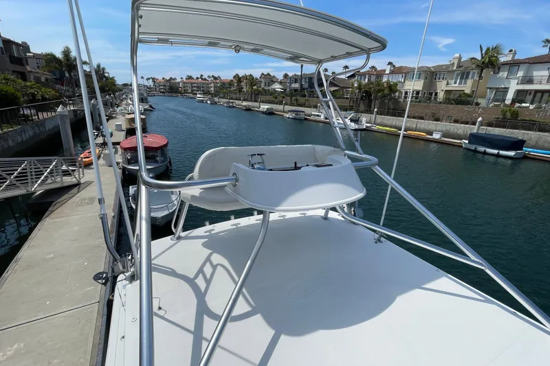 Slide: The Image of 2005 Rampage 33 Express boat docked in a scenic canal with waterfront homes. - 51