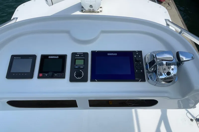 Slide: The Image of Control panel of 2005 Rampage 33 Express boat with Simrad electronics and throttle controls. - 52