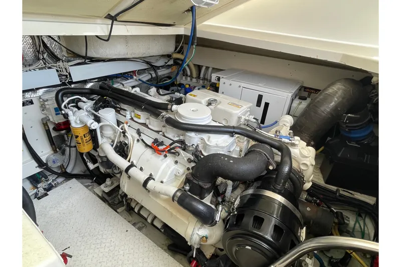 Slide: The Image of Engine room of a 2005 Rampage 33 Express boat, showcasing detailed machinery. - 56
