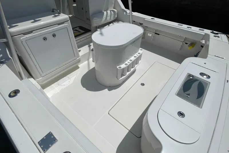 Slide: The Image of 2005 Rampage 33 Express boat deck with seating and storage compartments. - 8