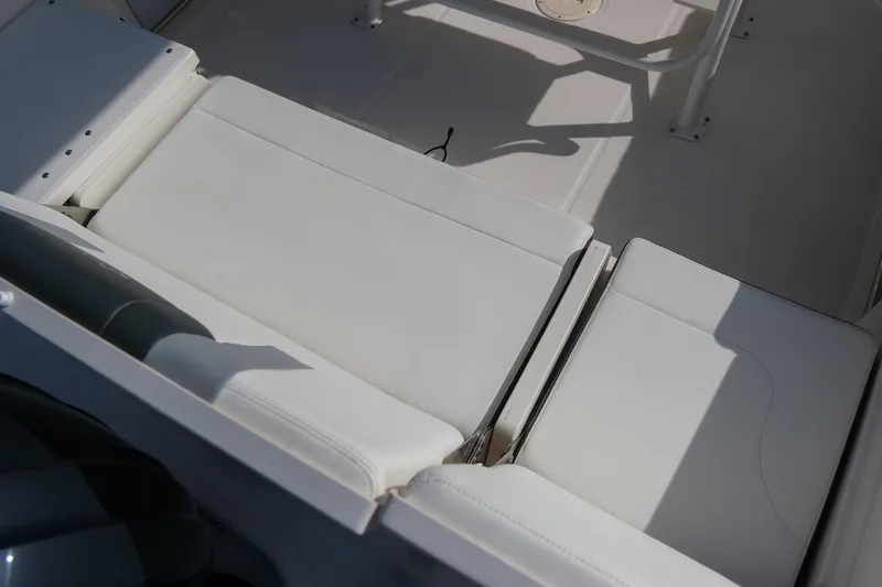 Slide: The Image of 2023 Robalo R230 Center Console boat seating area with white cushions. - 10