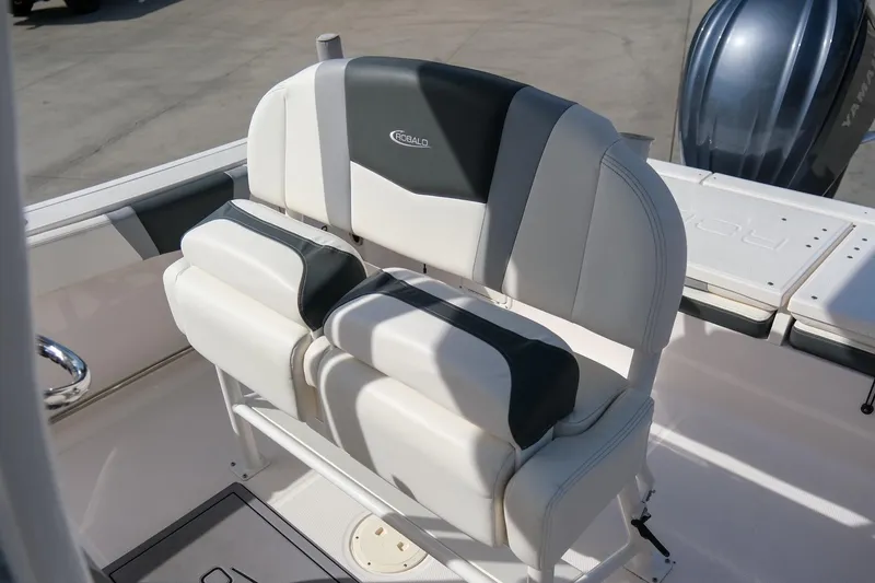 Slide: The Image of 2023 Robalo R230 Center Console boat seating with cushioned backrest and armrests. - 14