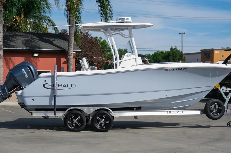 Slide: The Image of 2023 Robalo R230 Center Console boat on trailer with Yamaha engine, parked outdoors. - 5