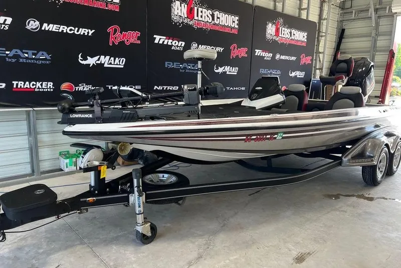 Slide: The Image of 2014 Skeeter FX 21 bass boat in showroom with promotional banners. - 1
