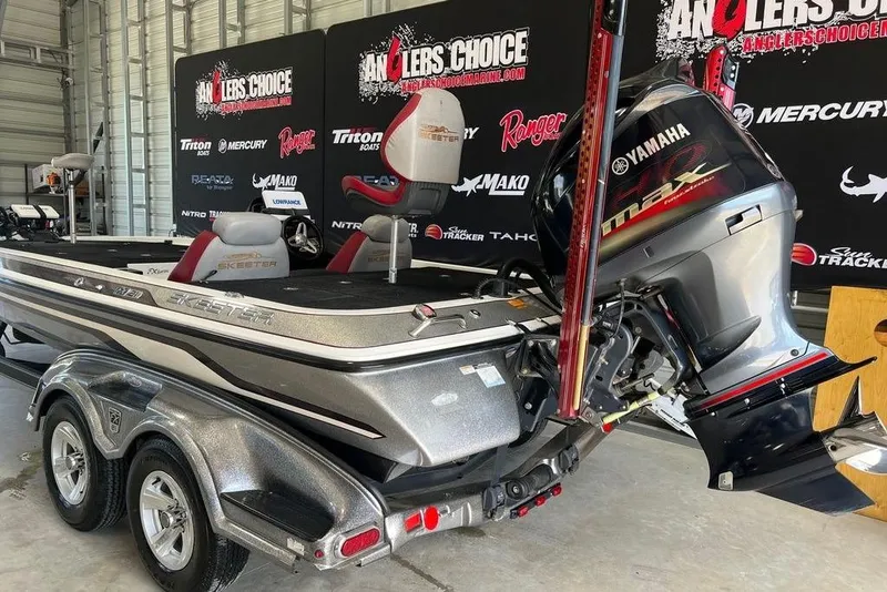Slide: The Image of 2014 Skeeter FX 21 boat with Yamaha engine in showroom setting. - 2