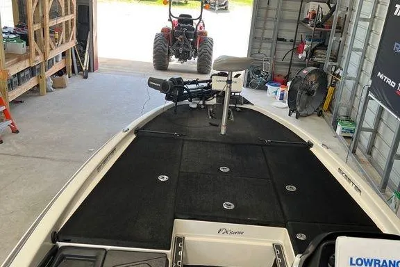 Slide: The Image of 2014 Skeeter FX 21 boat in garage, equipped with fishing gear and electronics. - 3