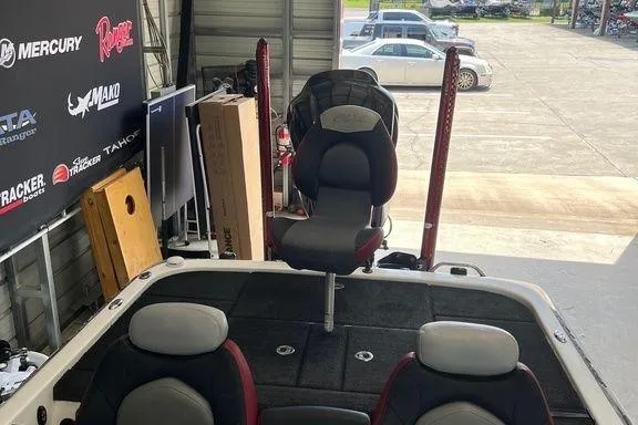 Slide: The Image of 2014 Skeeter FX 21 boat interior with seating and storage in a garage setting. - 6