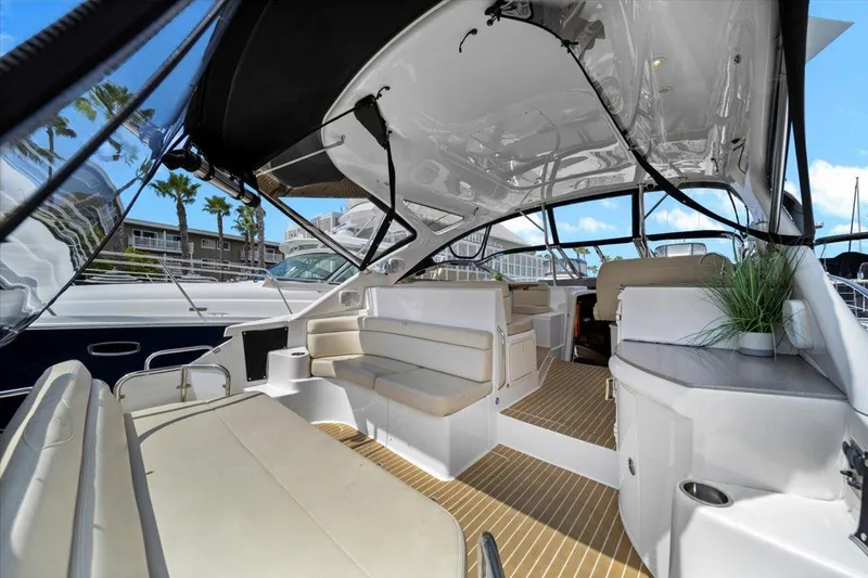Slide: The Image of 2010 Regal Commodore 4460 yacht interior with seating, modern design, and open canopy. - 18