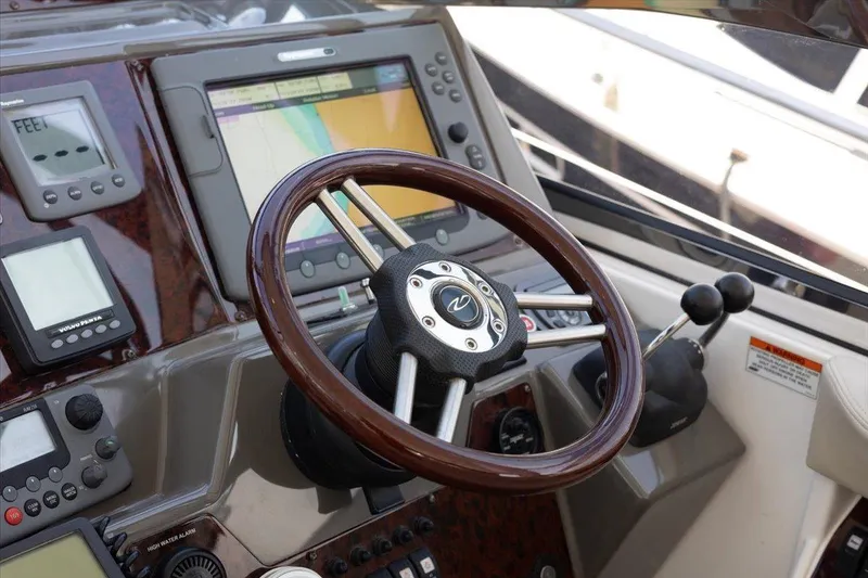 Slide: The Image of Steering wheel and controls of a 2010 Regal Commodore 4460 yacht cockpit. - 23