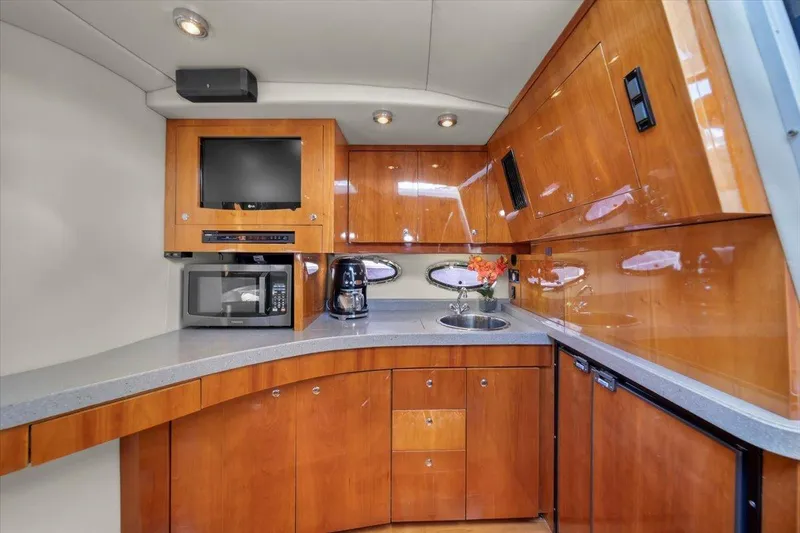 Slide: The Image of Luxurious 2010 Regal Commodore 4460 yacht kitchen with wood cabinetry and modern appliances. - 29