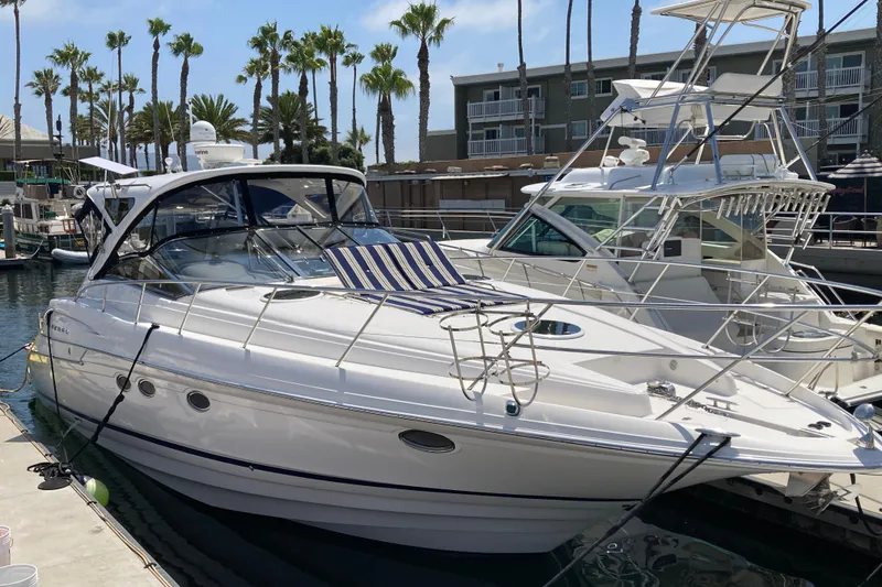 Slide: The Image of 2010 Regal 4460 Monterrey yacht docked at marina with palm trees in background. - 3