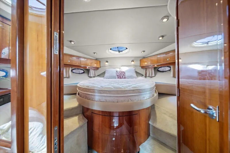 Slide: The Image of Luxurious interior of 2010 Regal Commodore 4460 yacht with elegant wood finish and cozy bed. - 30