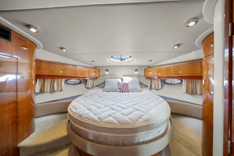 Slide: The Image of Luxurious cabin interior of 2010 Regal Commodore 4460 yacht with round bed and wood finish. - 31