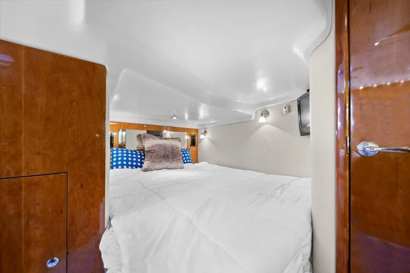Slide: The Image of Luxurious cabin interior of 2010 Regal Commodore 4460 yacht with cozy bedding. - 32