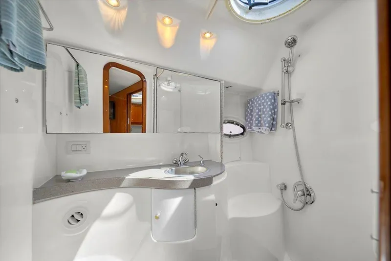 Slide: The Image of Luxurious bathroom in 2010 Regal Commodore 4460 yacht with modern fixtures and elegant design. - 34