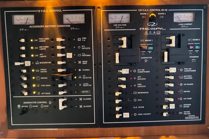 Slide: The Image of Control panel of a 2010 Regal Commodore 4460 boat, featuring electrical switches and indicators. - 38