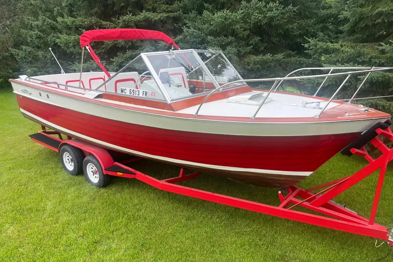 Slide: The Image of 1964 Chris-Craft Sea Skiff boat on red trailer, parked on grass. - 0