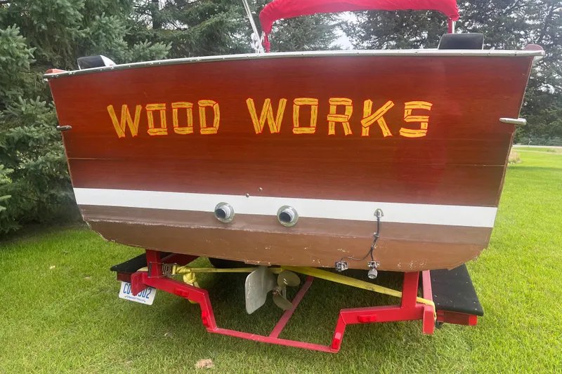 Slide: The Image of 1964 Chris-Craft Sea Skiff boat with "Wood Works" text on the stern, on a red trailer. - 4
