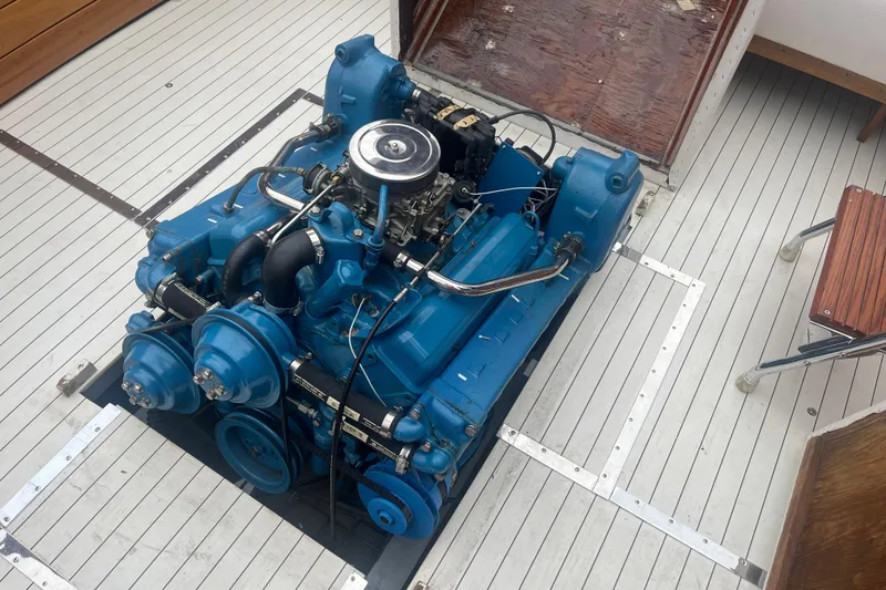 Slide: The Image of 1964 Chris-Craft Sea Skiff engine, blue, on a wooden boat deck. - 5
