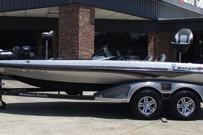 The Image of 2019 Ranger Z519L boat on trailer, parked outside a brick building. - 0