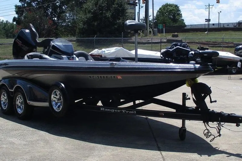 The Image of 2019 Ranger Z519L boat on trailer, parked outdoors, with triple-axle wheels. - 1