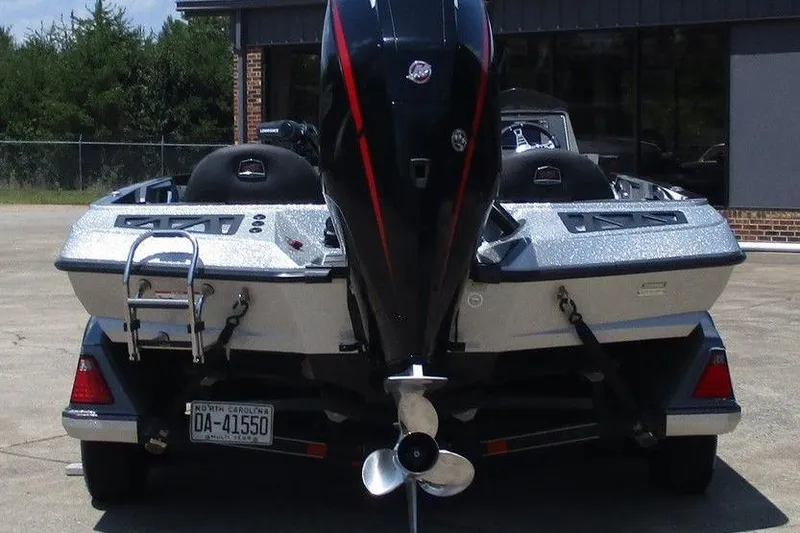 Slide: The Image of 2019 Ranger Z519L boat with powerful outboard motor, parked on concrete surface. - 5