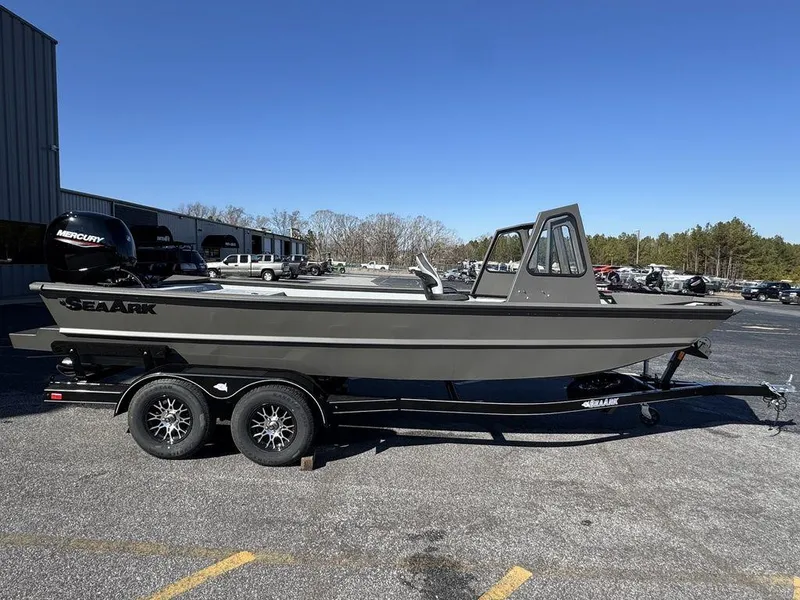 The Image of 2025 SeaArk 2072 MV Flat Cat boat on trailer, parked outdoors under clear blue sky. - 1